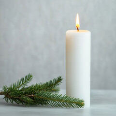 single white candle emits warm glow beside fresh evergreen branches, creating serene and minimalist holiday atmosphere. Perfect for festive decor or peaceful moments