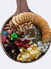 Cheese board with crackers and honey, with cereal