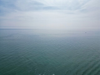 Fototapeta premium Aerial View of British Tourist Attraction of Beach and Ocean at Brighton and Hove Coastal City of England United Kingdom. High angle Footage of British Tourist Attraction Was Captured on May 9th, 2024