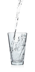 Pouring soda water into glass on white background