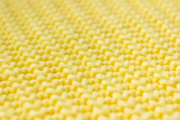 Texture of autumn knitted yellow sweater close up. Selective soft focus, place for text