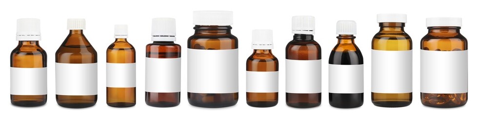 Many different glass bottles with labels isolated on white