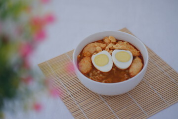 spicy egg noodle soup with crackers
