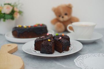 Chocolate cake on white plate with marble background
