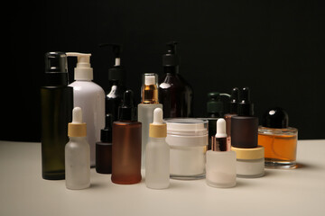 Assorted Skincare Bottles and Cream Jars in Minimalist Product Display