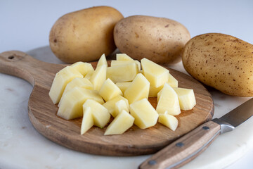 Chopped Potatoes on Wooden Cutting Board