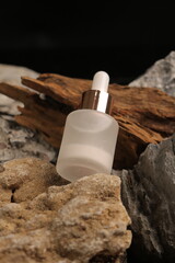 Frosted Glass Dropper Bottle with Rose Gold Cap on Rustic Stone Decor