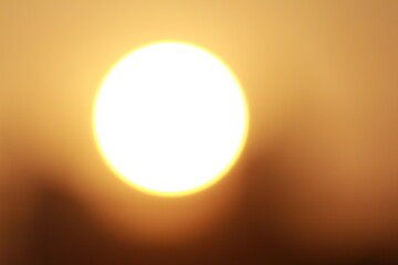 The blurred sunlight filled the sky with a warm golden glow, giving off a serene and peaceful atmosphere.