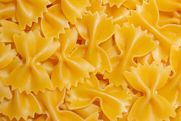 Uncooked Farfalle Pasta: A Culinary Canvas of Bow-Tie Macaroni, Creating a Lively and Textured...