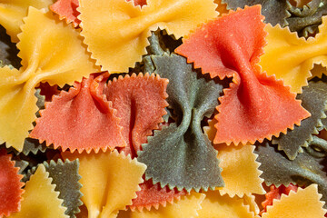 Uncooked Vibrant Colored Farfalle Pasta: A Culinary Canvas of Multicolored Bow-Tie Macaroni,...