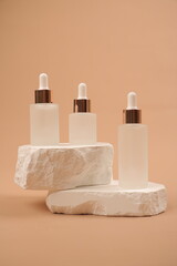 Frosted Glass Serum Dropper Bottles on White Stone Sculpture