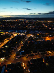 Fototapeta premium Aerial Night View of Illuminated Luton City Homes During Full Moon Night of October 27th, 2023