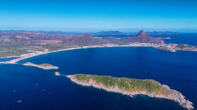 Aerial photo of Los Algodones beach in San Carlos Sonora, Mexico. The islands full of sahuaros stand out. An iconic contrast between desert and sea. In the background the rocky mountain Tetakawi.
