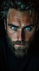 Obraz premium Close Up Portrait of a Man with Blue Eyes and a Beard, Dramatic Lighting