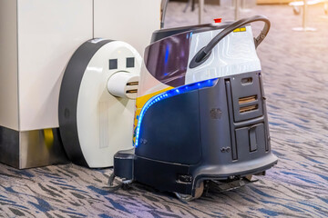 Industrial automatic robot cleaner mopping the floor in public place - airport, station, mall....