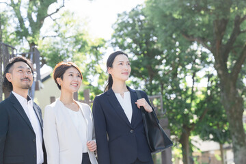 緑の中見上げる男女のビジネス,転職や保険営業マンなどのイメージ　広角