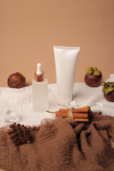 Frosted Glass Dropper Bottle with White Tubes and Cinnamon Sticks on Soft Fabric