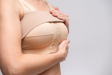 woman patient In post surgical Compression bra, implants stabilizer bra after plastic surgery...
