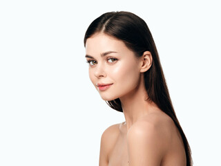 Beautiful young woman with long brown hair posing on white background, isolated on white background