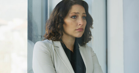 Obraz premium Business, woman and sad with thinking in office for corporate mistake, bankruptcy and financial crisis. Professional, person and disappointed with job loss, unemployment and depression by work window