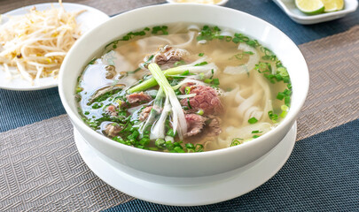 Vietnam traditional pho, Beef noodles. Pho Bo Soup with beef, rice noodles, ginger, lime, chili...