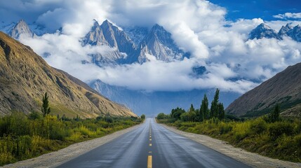 Naklejka premium Serene Mountain Road Under Dramatic Skies