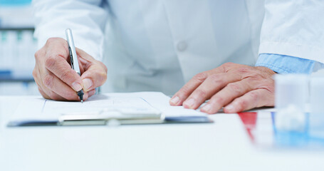 Doctor, hands and writing with prescription at pharmacy for medical documents, insurance or invoice at drug store. Closeup, healthcare employee or pharmacist with paperwork for pharmaceutical record