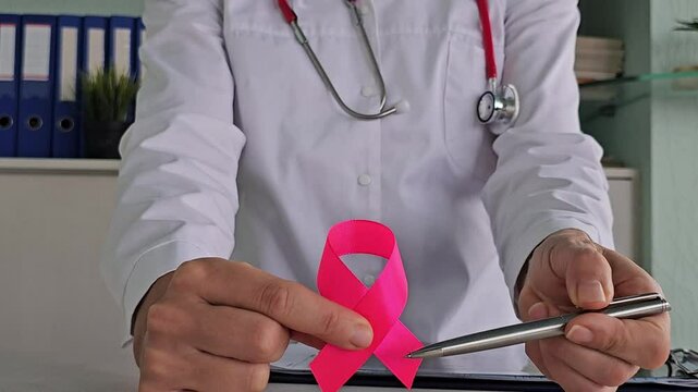 Pink October Breast Cancer Awareness Month Gynecologist with pink ribbon in hospital to support people