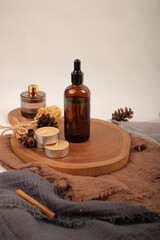 Amber Glass Dropper Bottles for Essential Oils on Wooden Tray with Candles