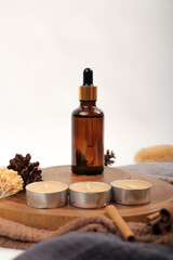 Amber Glass Dropper Bottles for Essential Oils on Wooden Tray with Candles