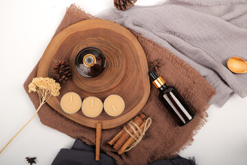 Amber Glass Dropper Bottles with Candles on Wooden Tray for Skincare and Aromatherapy