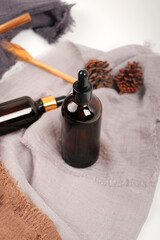 Amber Glass Dropper Bottle for Essential Oils on Soft Fabric Background