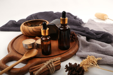 Amber Glass Dropper Bottles with Rustic Decor on Wooden Tray for Skincare and Aromatherapy