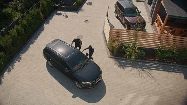 Top View Two Burglars Try to Break Into a Parked Car, but Are Frightened Away by a Guard Dog on Duty. Dogs in Preventing Car Theft and Enhancing Security in Parking Areas and Private Property.