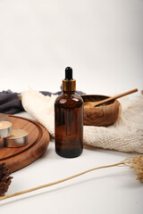 mber Glass Dropper Bottle with Wooden Accessories for Skincare Product Presentation