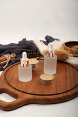 Frosted Glass Dropper Bottles on Wooden Tray for Skincare and Wellness Product Display