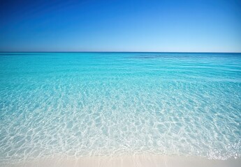 Obraz premium Tranquil Turquoise Ocean with Sandy Beach Background