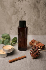 Amber Glass Bottle with Natural Elements and Rustic Decor on Concrete Background