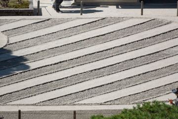 Japanese dry garden in Ginkakuji Temple, Kyoto, Japan. It creates a miniature stylized landscape through carefully composed arrangements of rocks