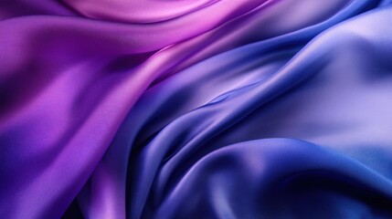 Obraz premium Smooth, flowing fabric in gradient shades of purple and blue, creates a soft, abstract background texture.