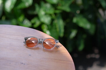 stylish glasses photographed on a wooden table with beautiful bokeh