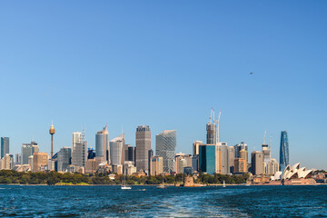 Sydney city skyline panorama viewed from ferry across the cove on a bright sunny day