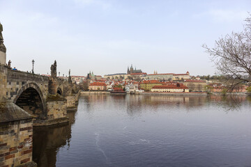 an arched stone bridge town over a river