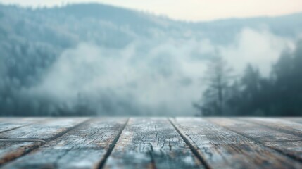 The wooden deck provides a serene vantage point of mist-covered mountains in a peaceful morning atmosphere