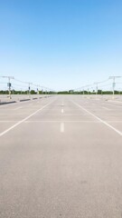 Fototapeta premium Empty parking lot with rows of white lines marking individual parking spots, lines