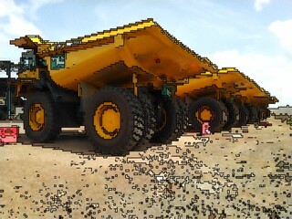 Obraz premium heavy equipment trucks in the mining area with haulpak models in pixels