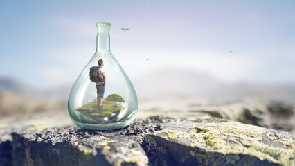 Young traveler inside glass bottle