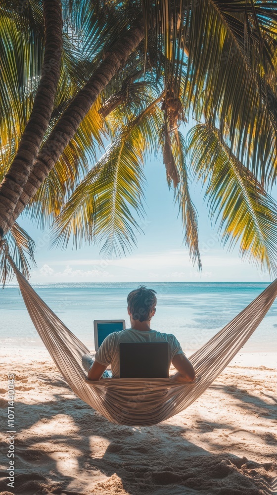 Wall mural a man working on laptop computer while relaxing in beach hammock