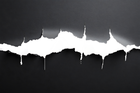 Torn black paper with jagged edges revealing a dark background.