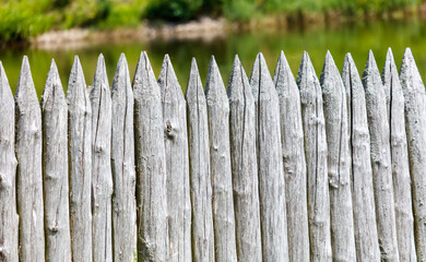 A wooden fence with a green background